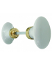 Bouton double ovale en porcelaine blanche et laiton poli.