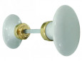 Double oval knob in white porcelain and polished brass.